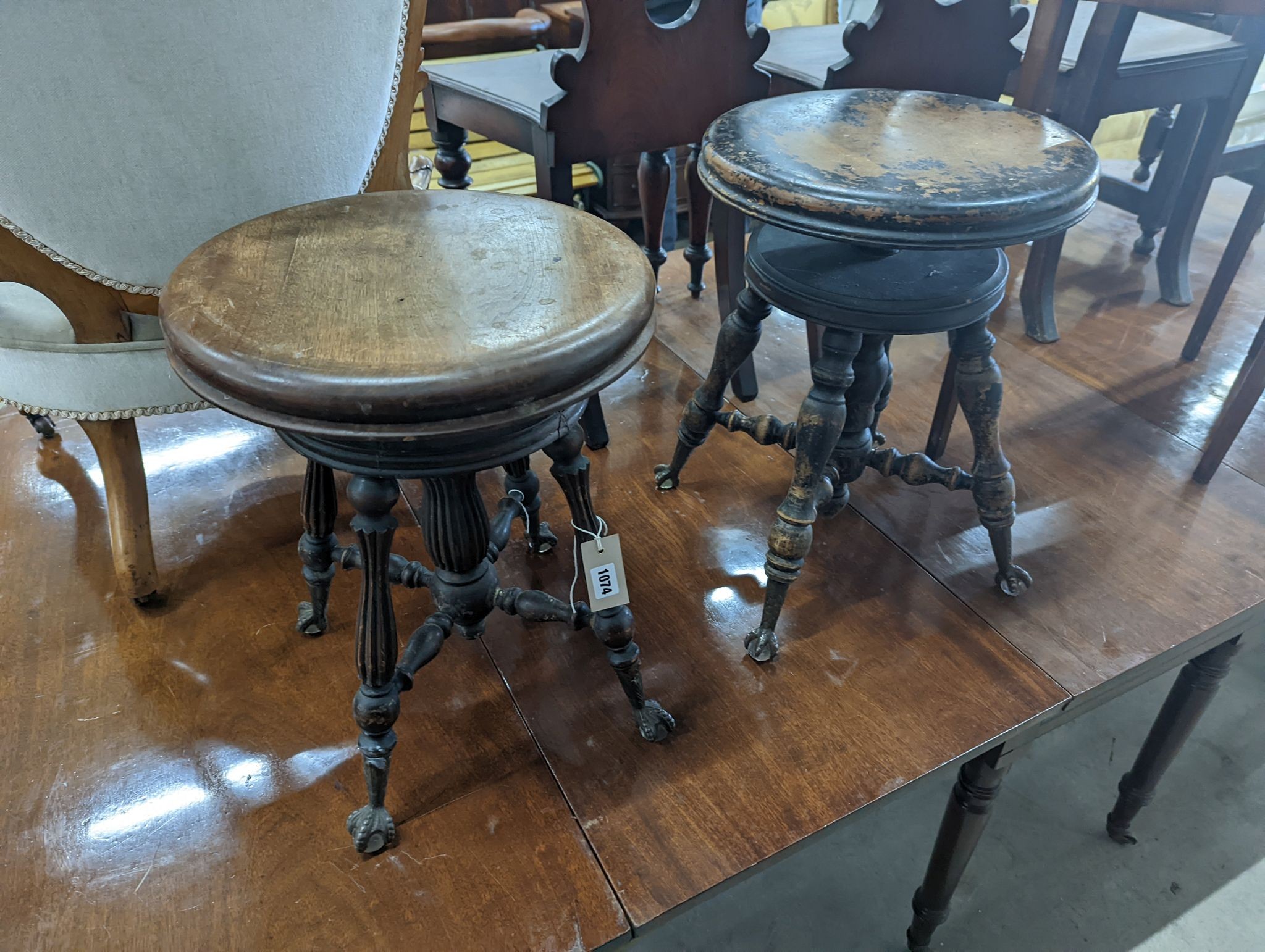 A near pair of Victorian mahogany and beech adjustable stools with revolving seats, larger diameter 36cm